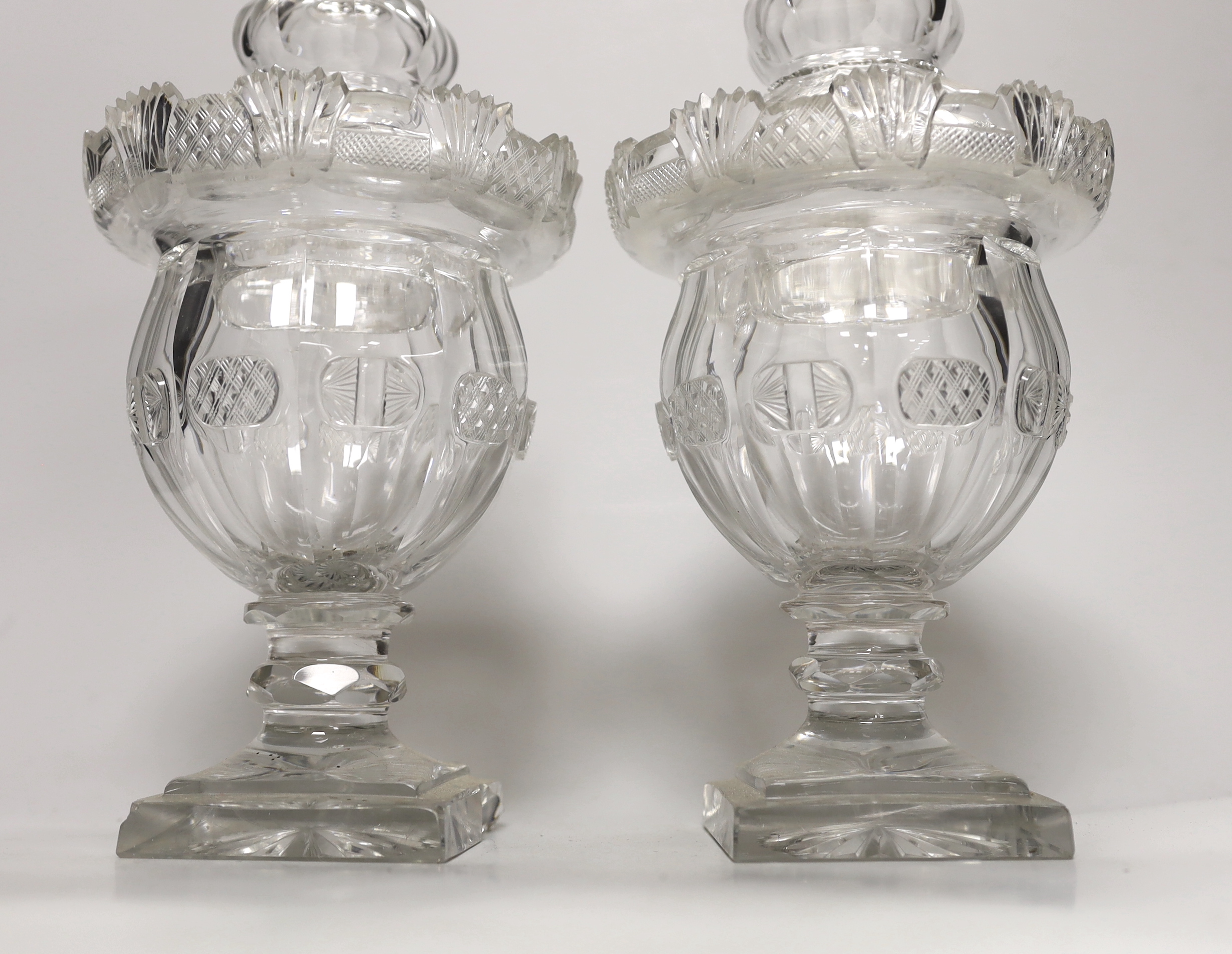 A pair of early Victorian cut glass pomade jars and covers, 30cm